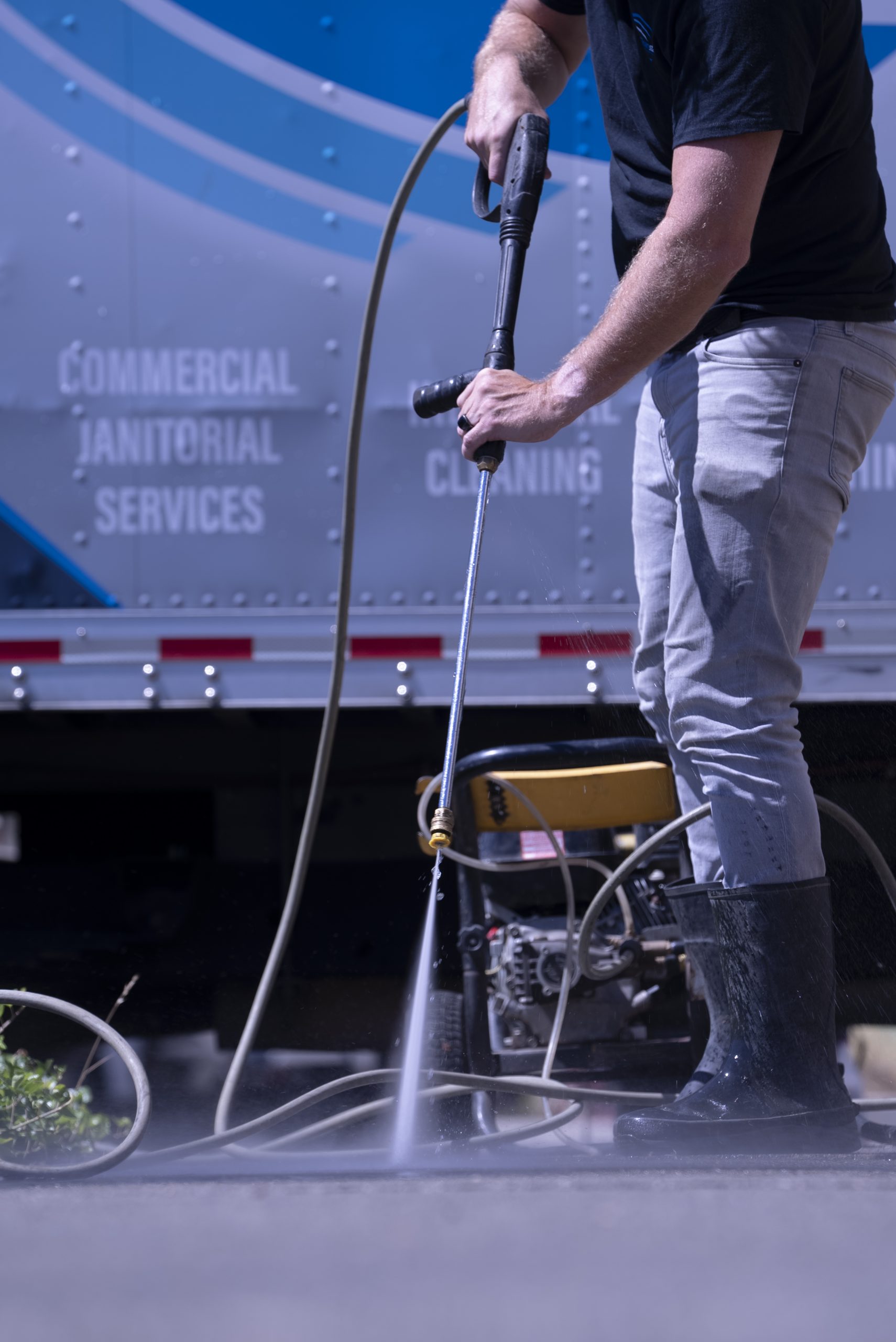 Cleanstart technician power washing a commercial vehicle